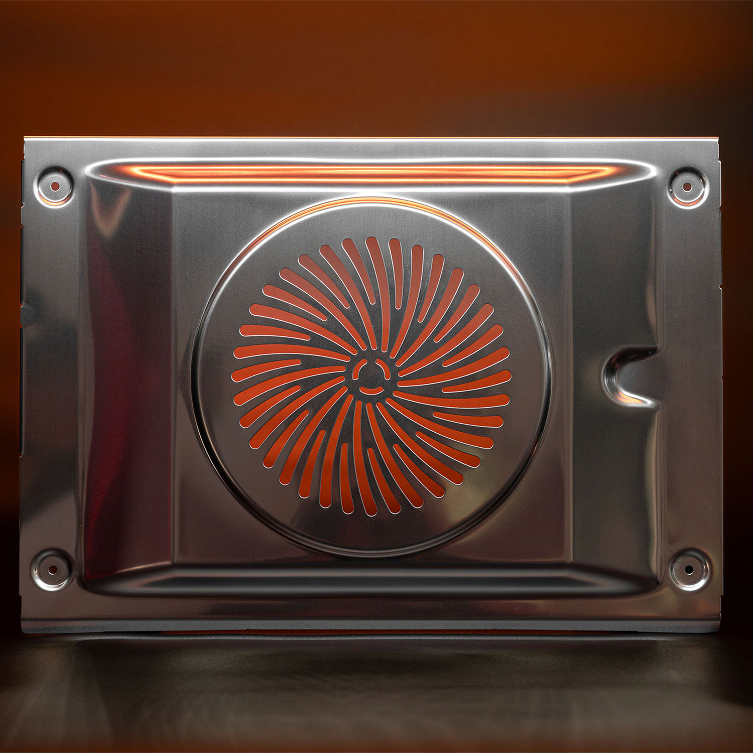 Close-up of a metallic oven interior panel with a reflective surface.