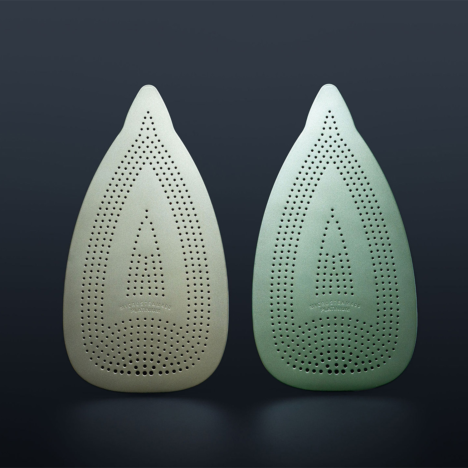 Two brushed iron soles with functional hole structure for steam irons.